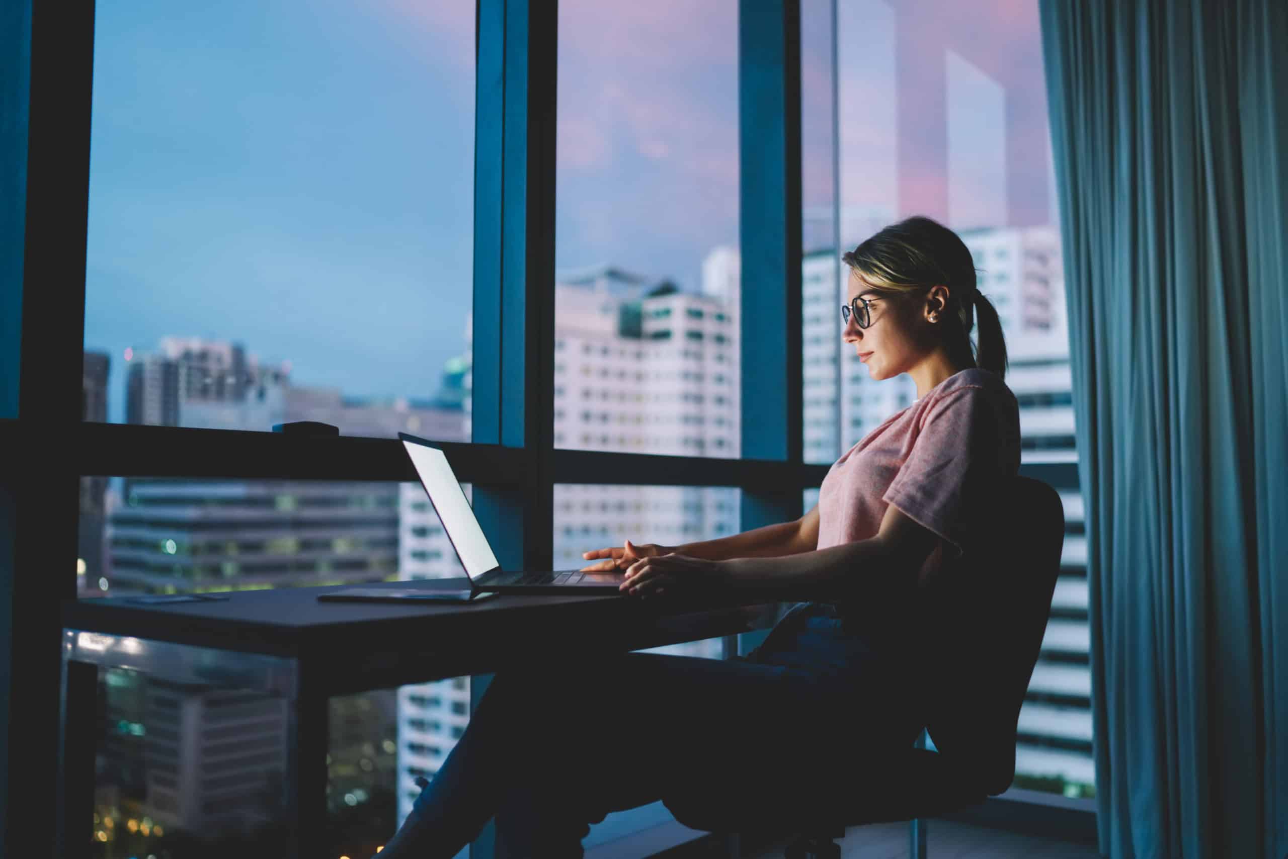 Young attractive skilled marketing expert in eyeglasses watching